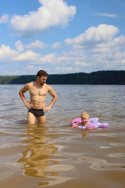 istock Father and son in the river 1411501685