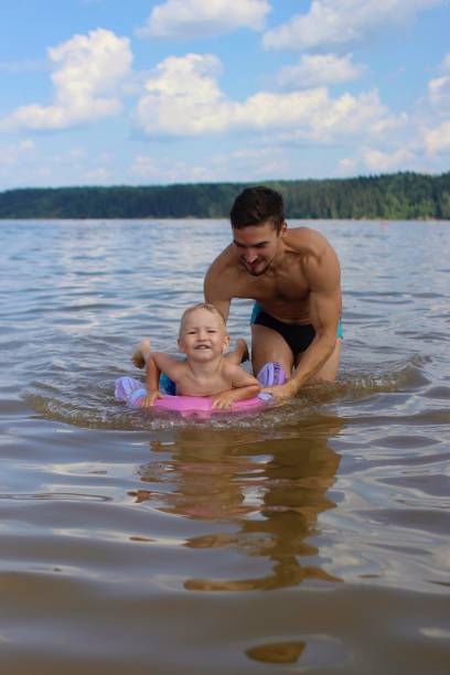 istock Father teaches son to swim 1411501709