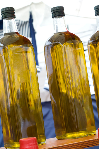 A colorful display of fresh Olive oil in a French street market.