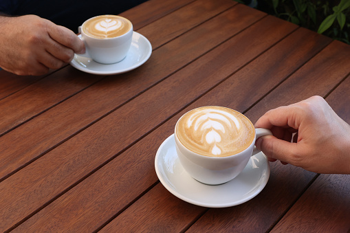 People drinking latte art coffee