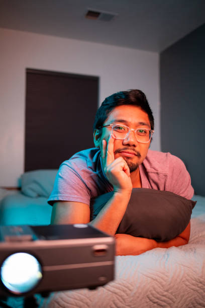 (Interested) Man Watching a Movie in Bed with Projector