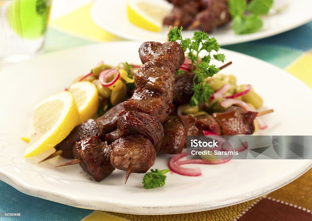 Lamb kebabs Grilled lamb kebabs with bean salad Kebab Stock Photo