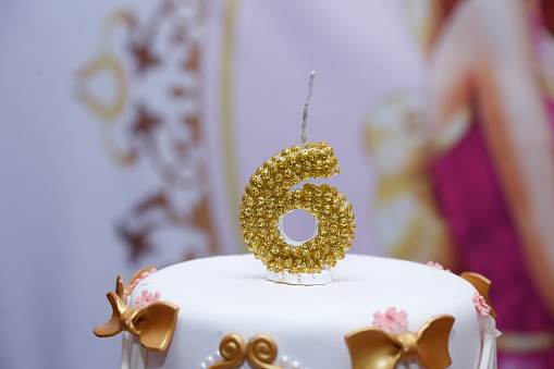 detail of the number six on the top of the birthday cake, 6th birthday, white cake, 6 year old birthday cake