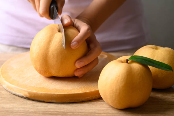 istock Asian pear or Nashi pear cutting on wooden board 1411514751