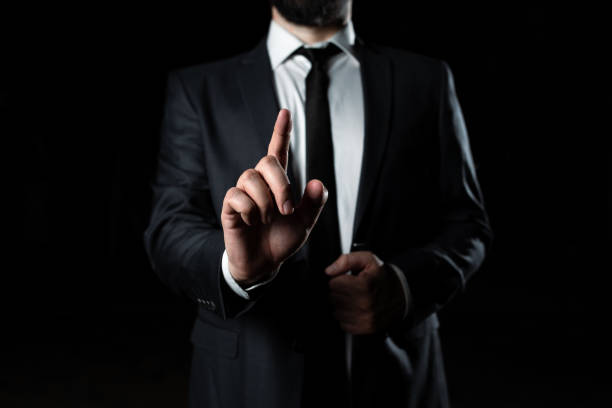 istock Businessman Pointing With One Finger On Important Message. Executive In Suit Presenting Crutial Information. Gentleman Showing Critical Announcement. 1411516400