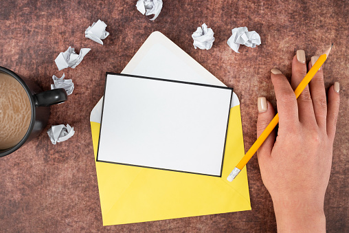 Woman With Sheet, Envelope, Coffee Cup, Pencil And Crumpled Papers.