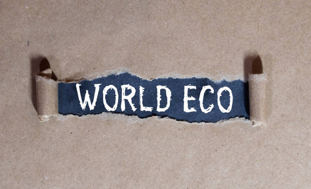 istock On the table is a globe and a marker, on a green background there is a cardboard with the inscription - WORLD ECO 1411517648