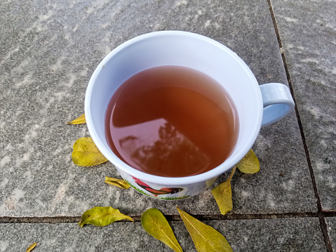 St. John's wort flower herbal tea in a white cup closeup