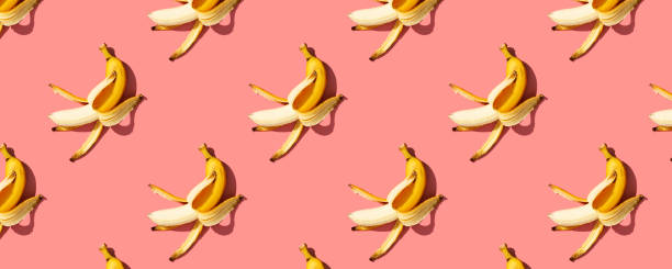 istock Yellow ripe  bananas on pink background pattern, banner 1411523954