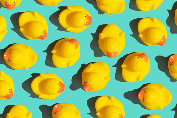 istock Collection of yellow rubber ducks on a blue background 1411523959