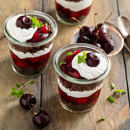 Black forest trifles, chocolate and cherry dessert in jars concept