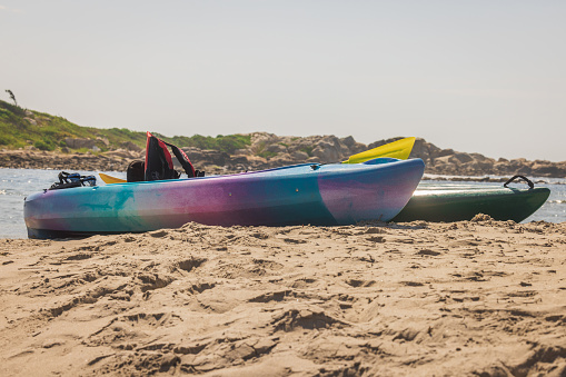 Two kayaks up on the beach in New England