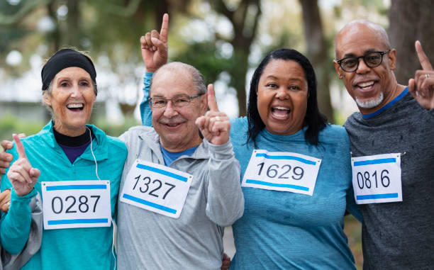 istock Two couples running race, make number one finger gesture 1411532930