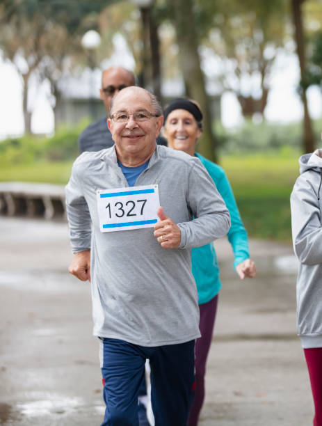 istock Senior man running in race, smiling 1411533040
