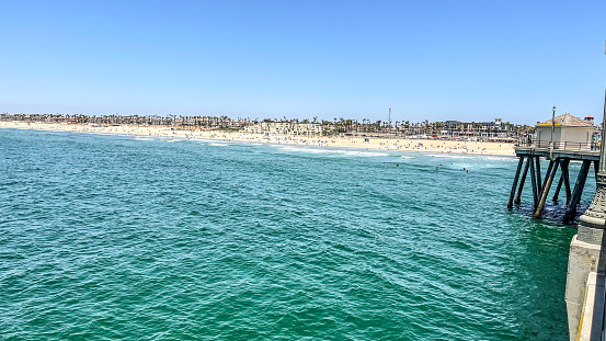 Huntington Beach, California is a great place to be on a sunny day. The beach and pier are inviting and a great leisure activity for tourists and locals alike.