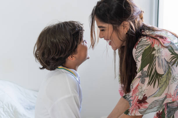 istock Latin mother getting son ready for school 1411536500