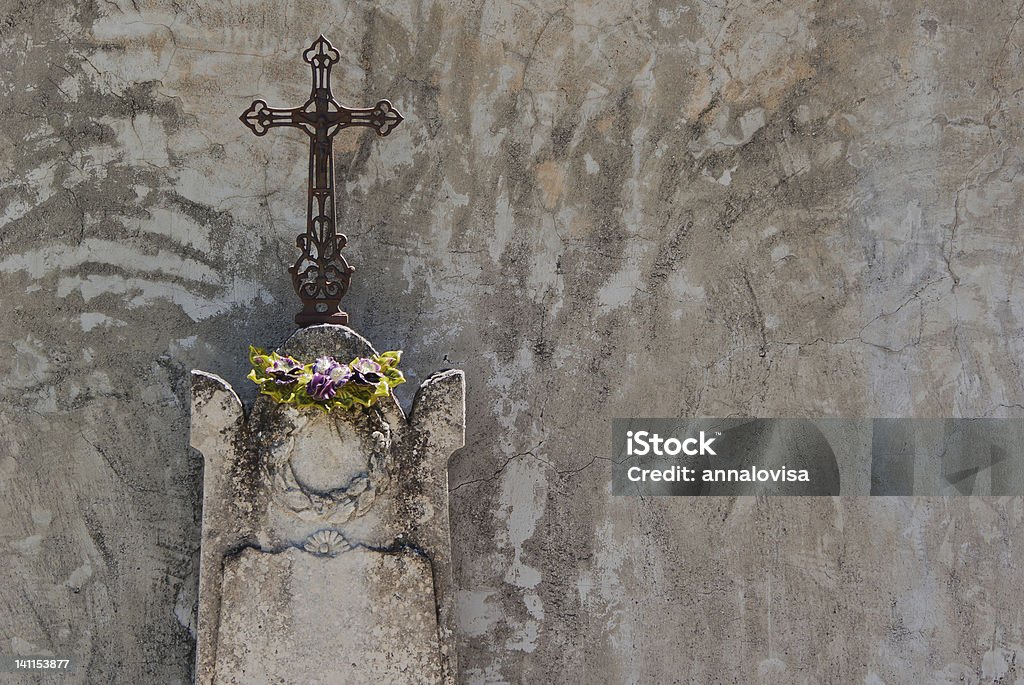 Cross Religious cross on a stone statue on a cemtery in France. Brown Stock Photo