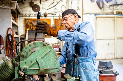 A 94 year old WW2 Navy Vet farmer working in his workshop