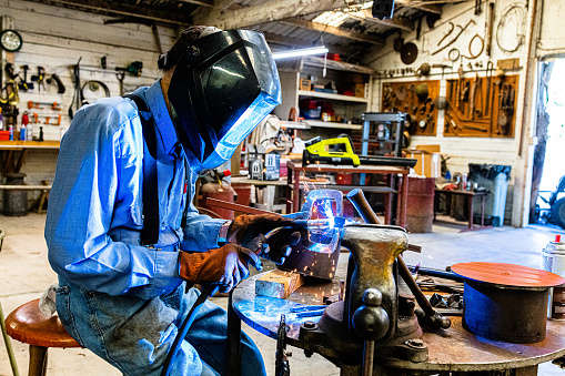 A 94 year old WW2 Navy Vet farmer working in his workshop