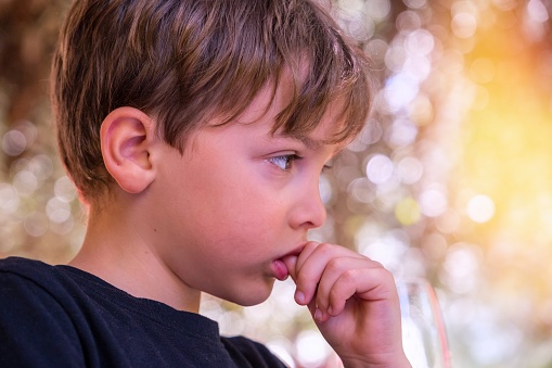 Sad, pensive little boy looking away