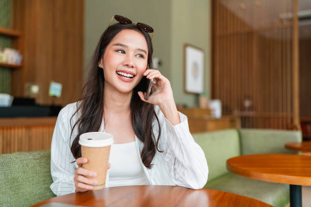 istock attractive smart casual asian female hand typing chat using smartphone telecommunication positive attitude smile in cafe casual,smart business owner entrepreneur working with smartphone in cafe 1411542543