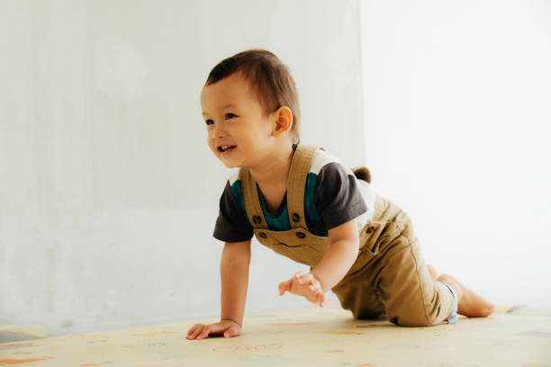 istock asian cute baby crawling on the floor 1411543915