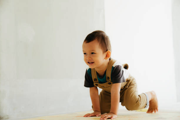 istock asian cute baby crawling on the floor 1411543918