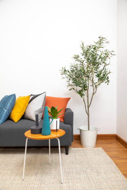 istock Yellow, blue and orange pillows on grey sofa. 1411546786