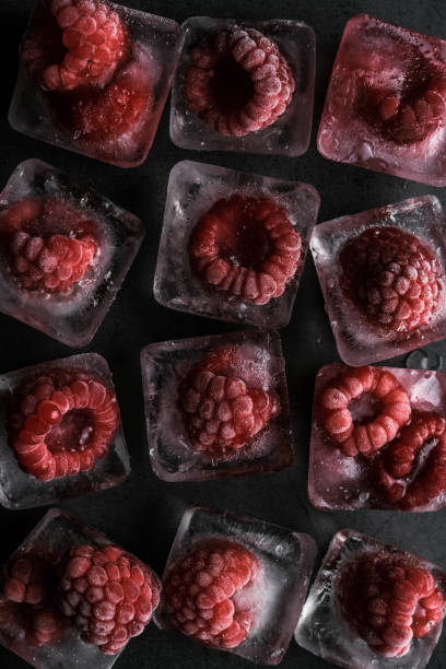 istock Fresh frozen red raspberry on dark background. 1411550641