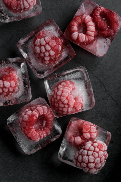 istock Fresh frozen red raspberry on dark background. 1411550644
