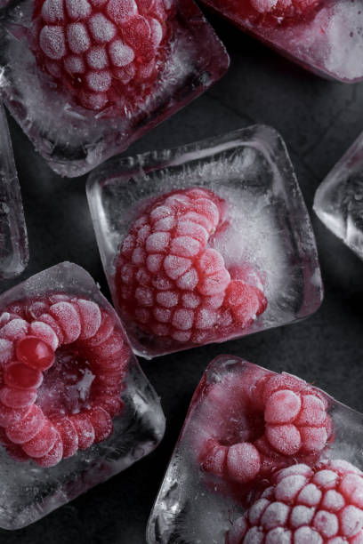 istock Fresh frozen red raspberry on dark background. 1411550645