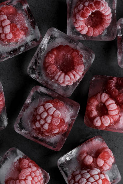 istock Fresh frozen red raspberry on dark background. 1411550649