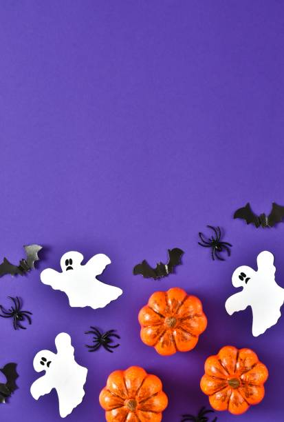 istock Happy Halloween flat lay composition with pumpkins, ghosts, spiders, bats on very peri purple background 1411551692