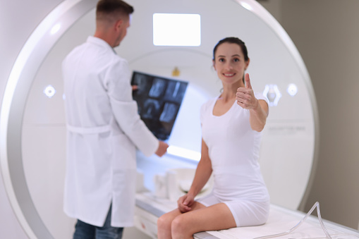 MRI machine satisfied patient and doctor with x-ray. Recommend quality medical services concept