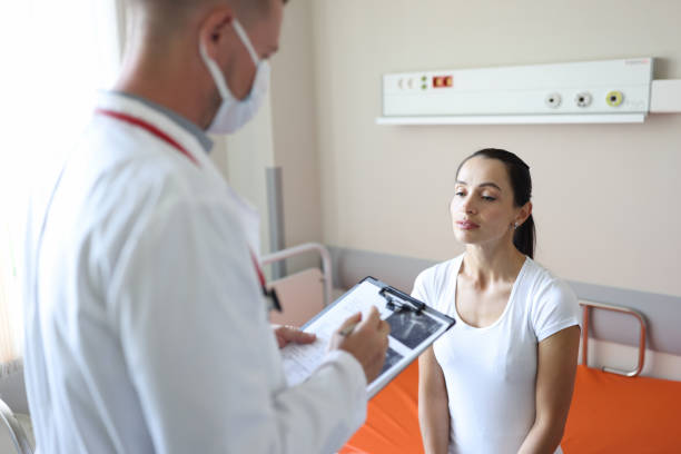 istock Doctor in mask communicates with patient in clinic 1411554792