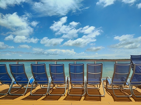 deck chair facing sea during day time on cruise ship