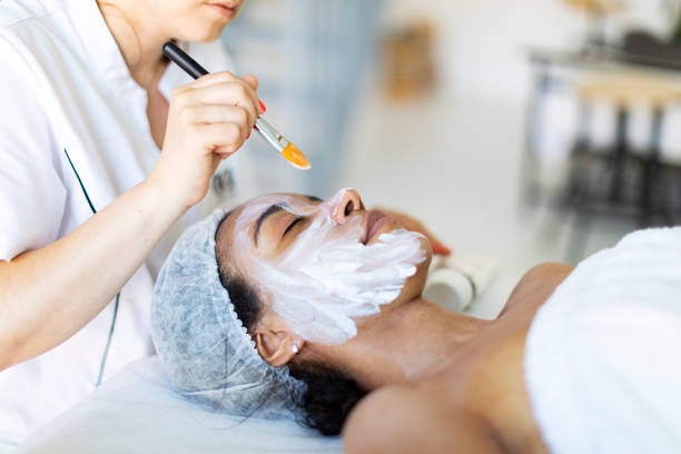 istock Cosmetologist making face massage at home 1411557043