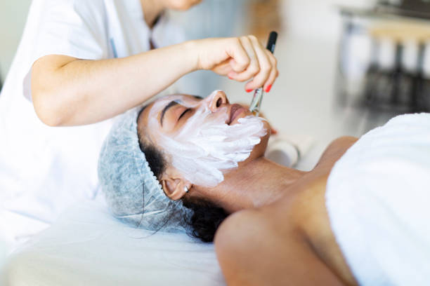 istock Cosmetologist making face massage at home 1411557054