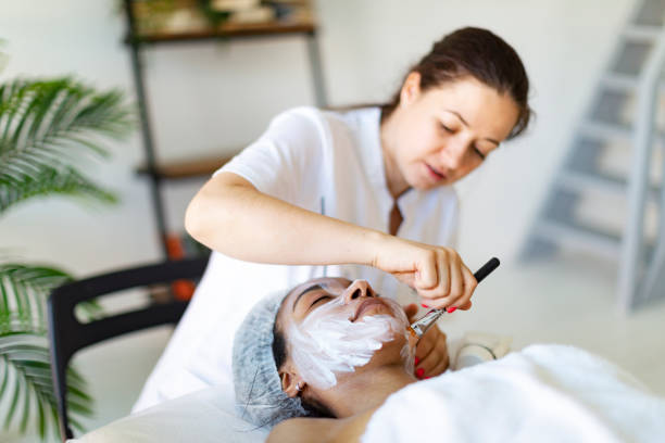 istock Cosmetologist making face massage at home 1411557067