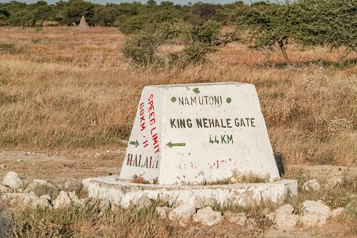 Road Sign to King Nehale Gate in Etosha National Park at Kunene Region, Namibia.  Nehale lya Mpingana, who died on 28 April 1908, belonged to the Omukwaniilwa of Ondonga, which is a subtribe of the Owambo. His reign lasted from about 1884 until his death. His area of rule was around Namutoni in the present-day Etosha National Park.