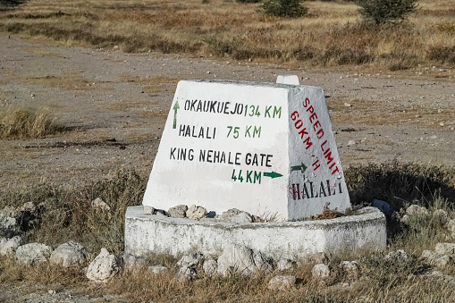 Road Sign to King Nehale Gate in Etosha National Park at Kunene Region, Namibia.  Nehale lya Mpingana, who died on 28 April 1908, belonged to the Omukwaniilwa of Ondonga, which is a subtribe of the Owambo. His reign lasted from about 1884 until his death. His area of rule was around Namutoni in the present-day Etosha National Park.