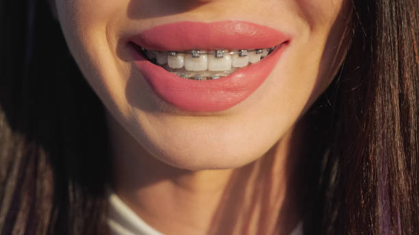 istock Young brunette with pink lipstick smiles at the camera 1411561720