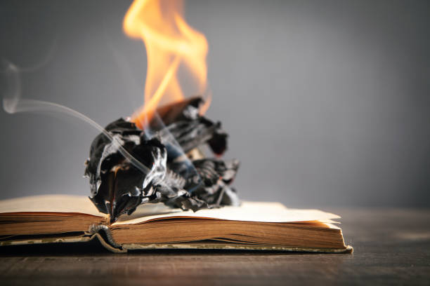 istock Burning book on the wooden table. 1411564002
