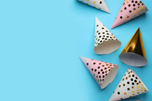 istock Bright party hats on light blue background, flat lay. Space for text 1411566253