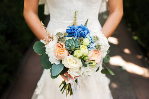 istock Bright wedding bouquet in hands of the bride 1411566918