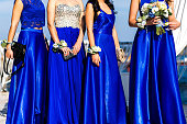 Bridesmaids with flowers stand at the wedding ceremony