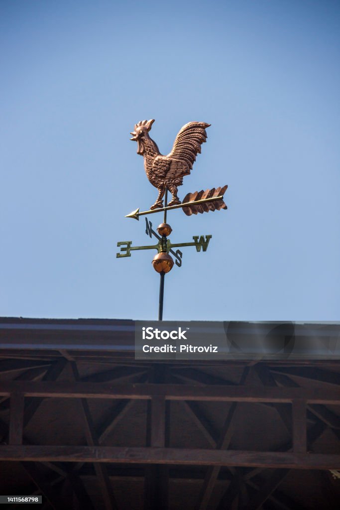 a weathercock on the top of the roof a copper decorative weathercock on the top of the roof Weather Vane Stock Photo