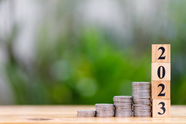 istock Money saving concept for new year 2023 with coins stacking and copyspace 1411569088