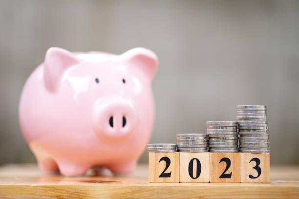 istock Money saving concept for new year 2023 with coins stacking and copyspace 1411569089