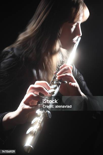 Flute Playing Flutist Classical Musician Stock Photo - Download Image Now - Black Background, Classical Musician, Blowing